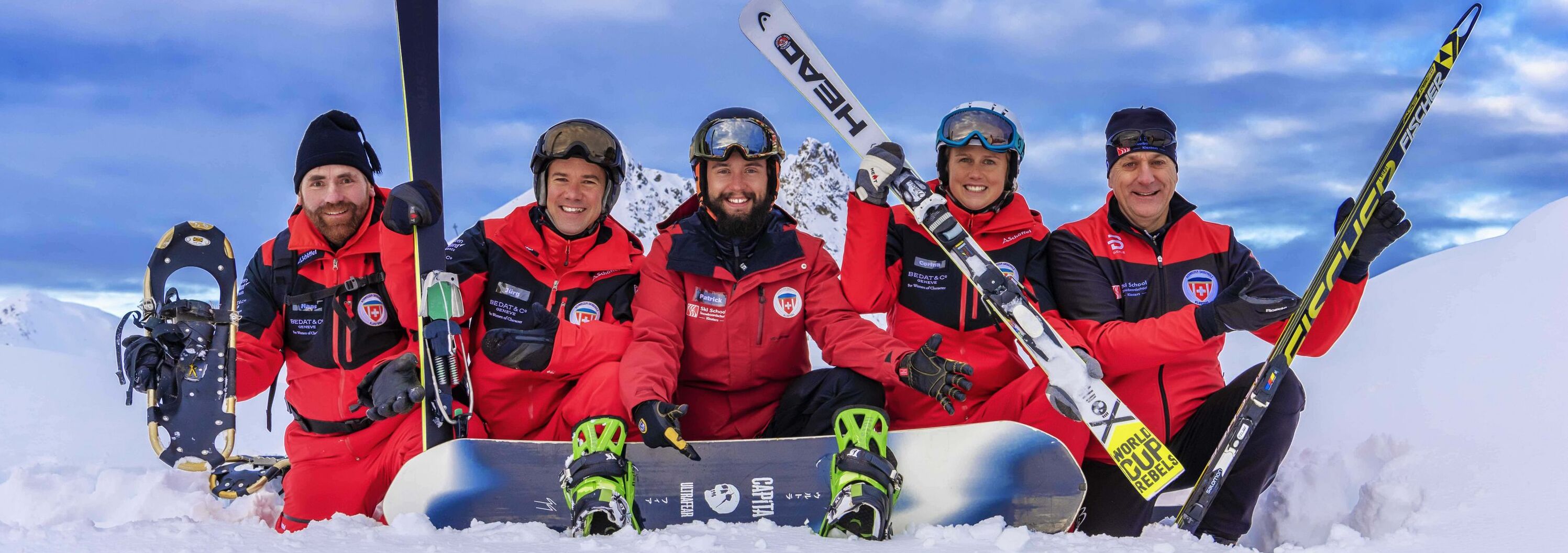 Klosters Ski School team posing in the ski area 